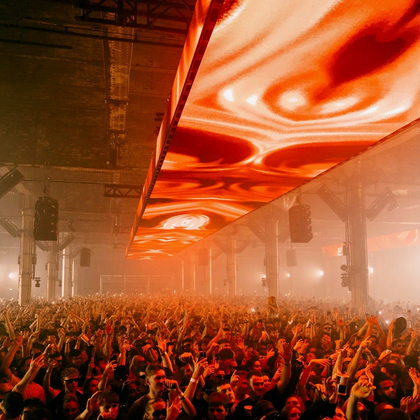 A crowd beneath the illuminated ceiling at The Warehouse Project